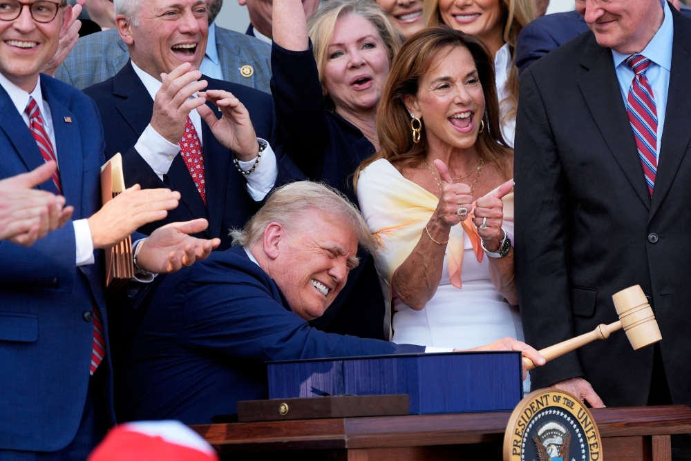 US President Donald Trump bangs a gavel after signing his signature bill of tax breaks and spending cuts at the White House in Washington, July 4, 2025. — Reuters pic 