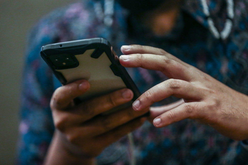 A preacher's mobile phones contained several sex videos involving the suspect and his wives, as well as compromising images of several other women. — Picture by Hari Anggara