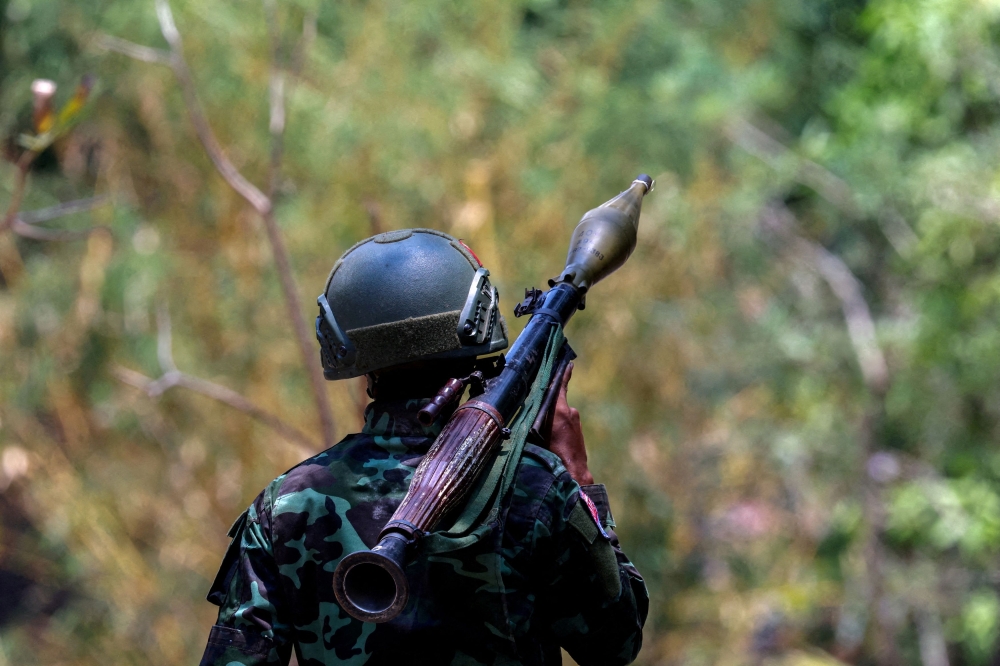 A soldier from the rebel Karen National Liberation Army (KNLA) carries an RPG launcher near a Myanmar military base at Thingyan Nyi Naung village on the outskirts of Myawaddy, the Thailand-Myanmar border town, April 15, 2024. — Reuters pic