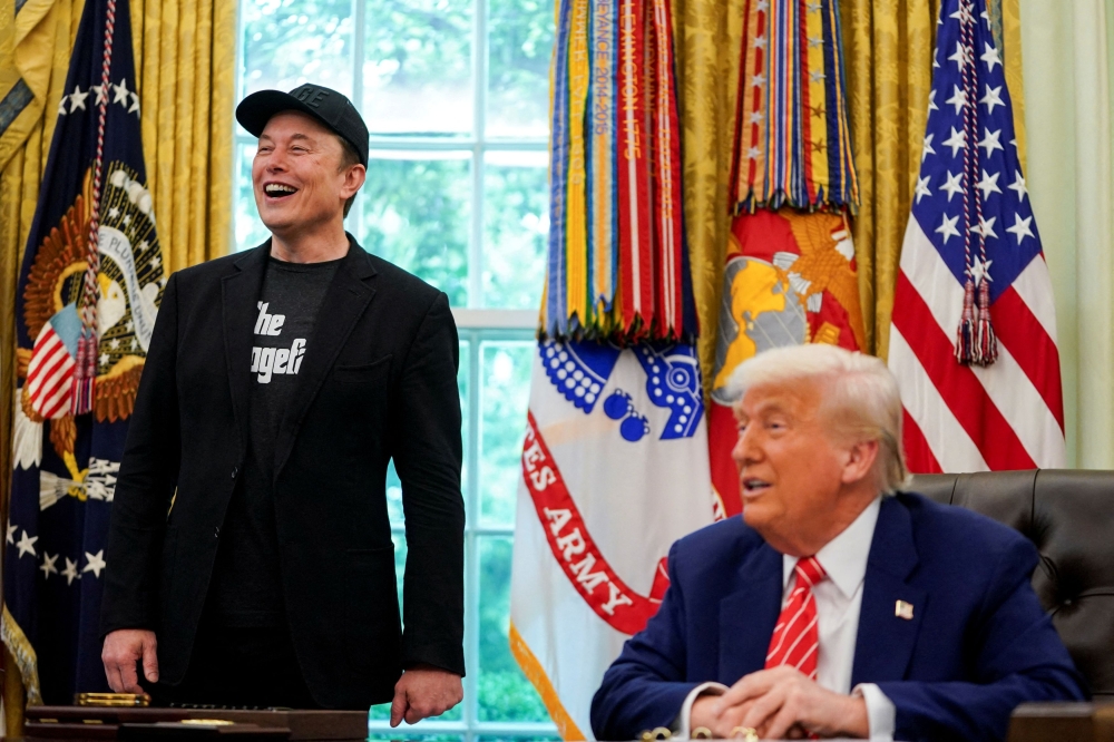 US President Donald Trump and Elon Musk attend a press conference in the Oval Office of the White House in Washington May 30, 2025. — Reuters pic