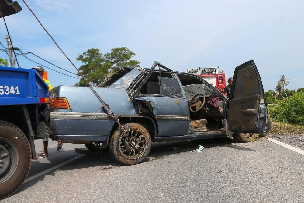 A Proton Iswara is seen after it is pulled from Sungai Korok in Jitra, Kedah. — Facebook pic