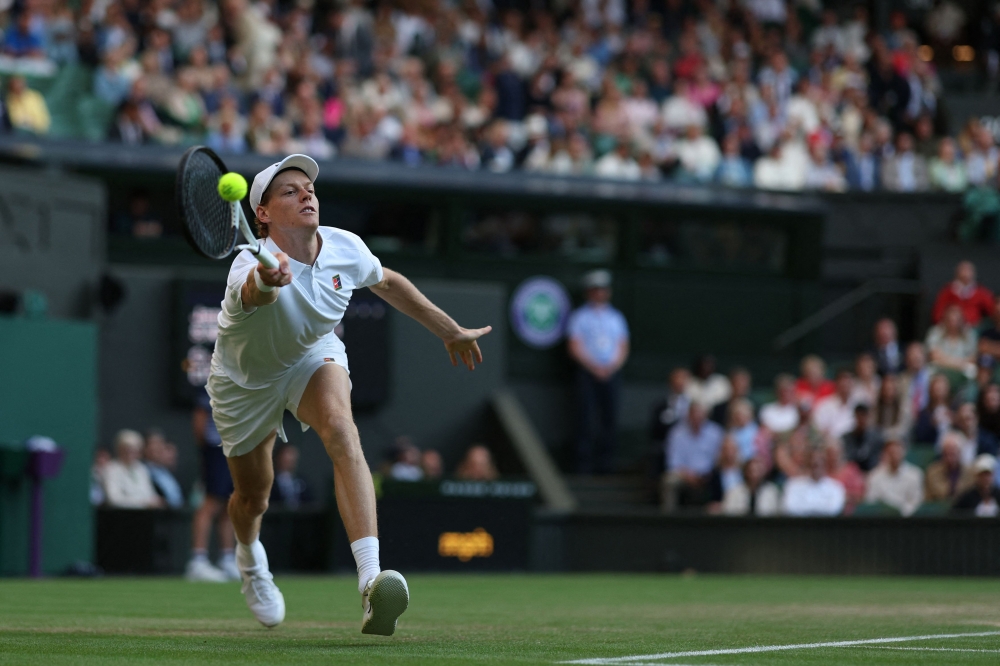 Italy's Jannik Sinner plays a forehand return to Bulgaria's Grigor Dimitrov during their men's singles fourth round tennis match on the eighth day of the 2025 Wimbledon Championships at The All England Lawn Tennis and Croquet Club in Wimbledon. — AFP pic