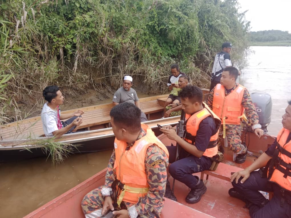 Villagers and rescue workers take part in the search for the missing man. — Fire and Rescue Dept pic