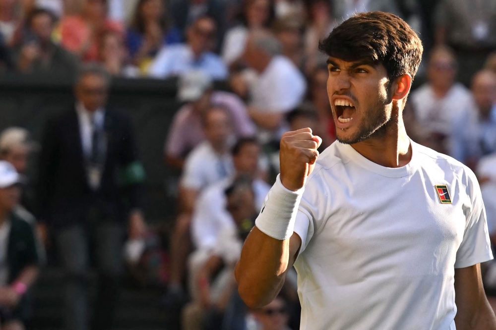 Spain's Carlos Alcaraz celebrates after winning against Britain's Cameron Norrie during their men's singles quarter-final tennis match on the ninth day of the 2025 Wimbledon Championships at The All England Lawn Tennis and Croquet Club in Wimbledon, south-west London July 8, 2025. — AFP pic 