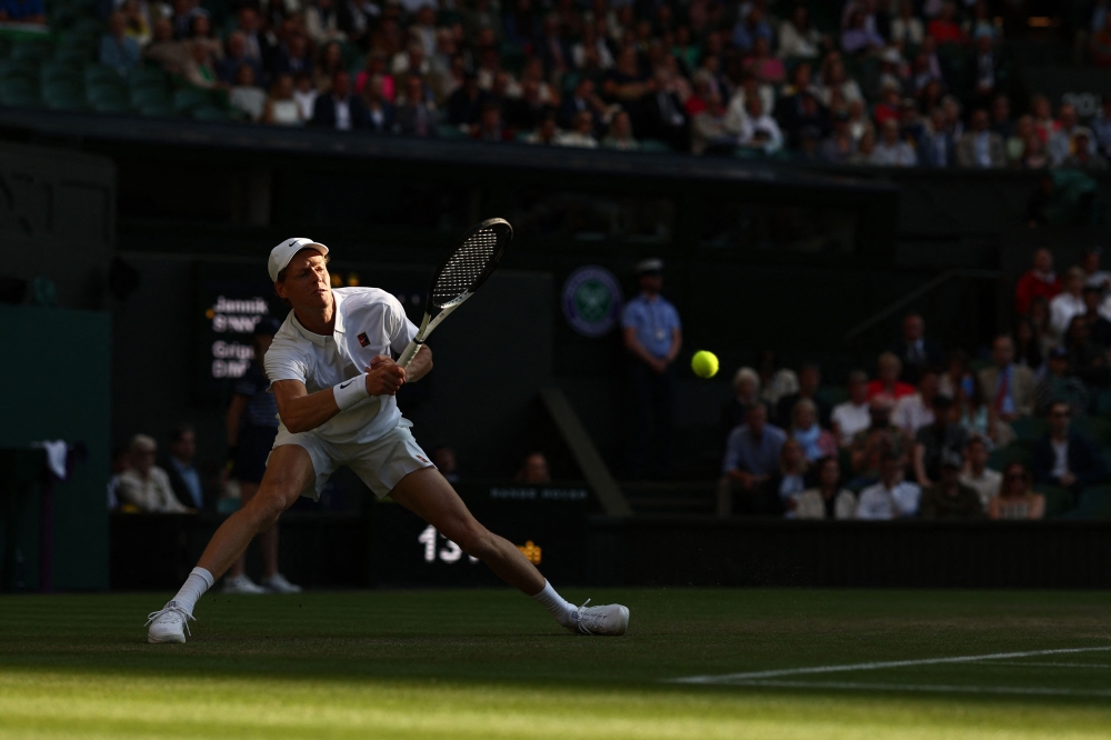 Italy's Jannik Sinner returns the ball to Bulgaria's Grigor Dimitrov during their men's singles fourth round tennis match on the eighth day of the 2025 Wimbledon Championships at The All England Lawn Tennis and Croquet Club in Wimbledon July 7, 2025. — AFP pic 