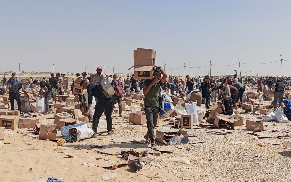 Palestinians collect what remains of relief supplies from the distribution centre of the US-backed Gaza Humanitarian Foundation, in Rafah, in the southern Gaza Strip, June 5, 2025. — Reuters pic