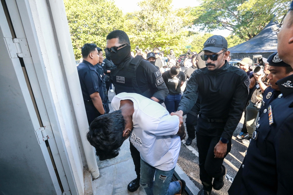M. Sri Darvien and D. Thineswary are escorted into the Sepang Magistrate’s Court to face charges, on July 10, 2025. — Picture by Sayuti Zainudin