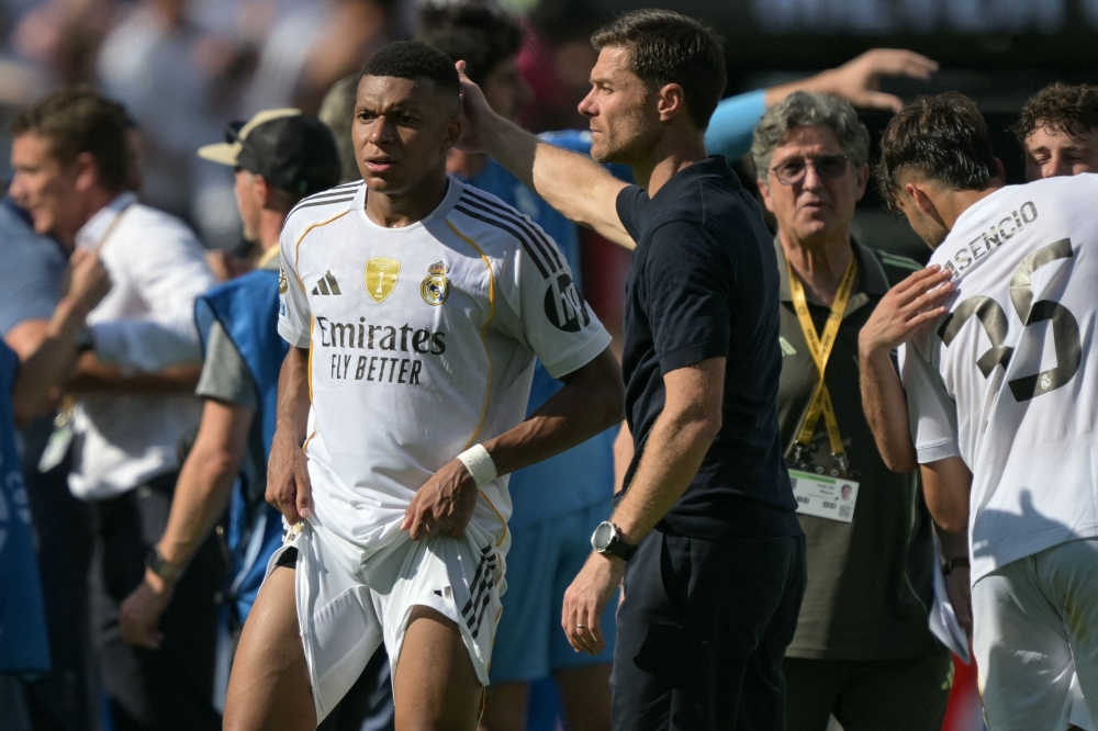Real Madrid's Spanish coach Xabi Alonso cheers French forward Kylian Mbappe after losing the FIFA Club World Cup 2025 semifinal football match with France's Paris Saint-Germain at the MetLife stadium in East Rutherford, New Jersey on July 9, 2025. — AFP pic