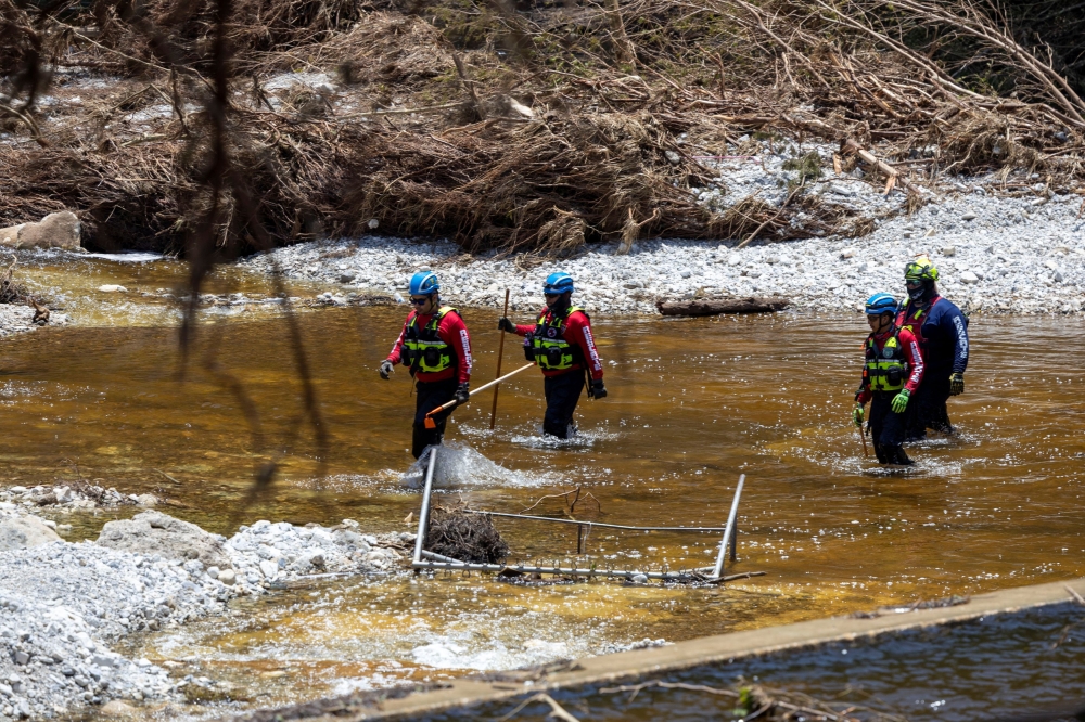 Search and rescue team members look for missing people in the waters of the Guadalupe River, near Camp Mystic, following deadly flooding, in Hunt, Texas July 10, 2025. — Reuters pic
