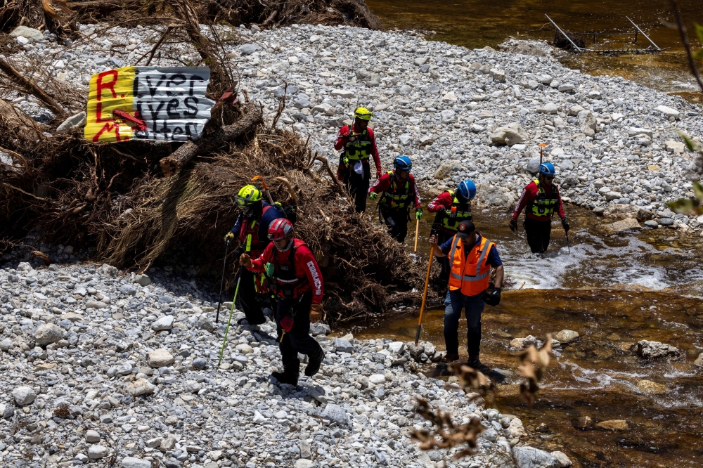 Search and rescue team members look for missing people amid debris in the waters of the Guadalupe River, near Camp Mystic, following deadly flooding, in Hunt, Texas July 10, 2025. — Reuters pic