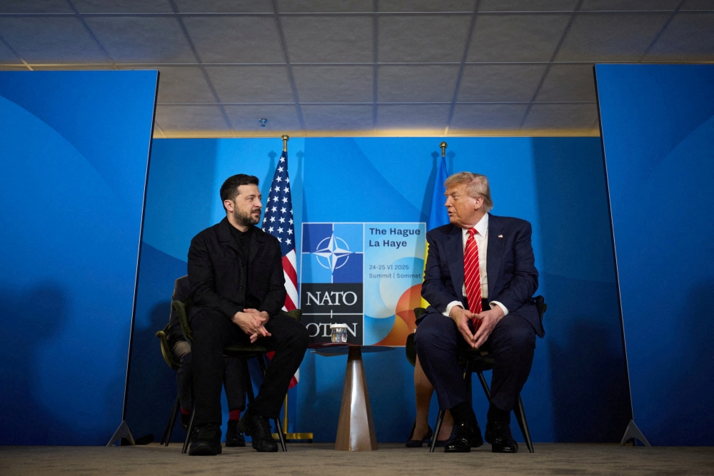 US President Donald Trump and Ukraine’s President Volodymyr Zelenskiy attend a meeting at the Nato summit in The Hague June 25, 2025. — Ukrainian Presidential Press Service handout pic via Reuters