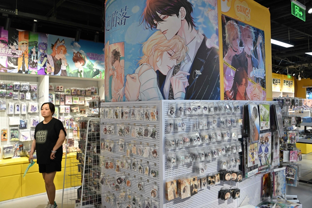 Posters featuring boy's love are seen as people visit a merchandise shop in Beijing July 9, 2025. — AFP