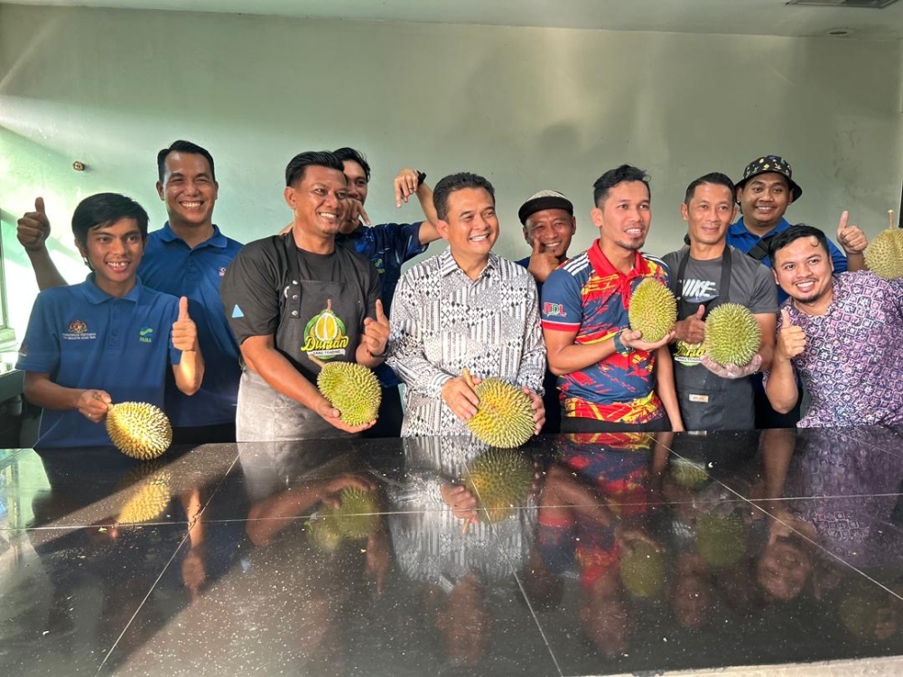Johor Agriculture, Agro-Based Industry and Rural Development Committee chairman Datuk Zahari Sarip (centre) promoting locally-grown fruits at the Johor FAMA office in Johor Baru on July 11, 2025. — Picture by Ben Tan