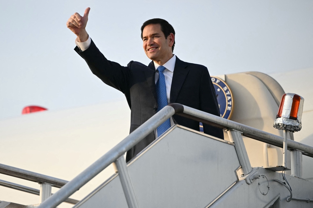 US Secretary of State Marco Rubio gestures as he boards his flight before departing from Subang Air Base, on the outskirts of Kuala Lumpur, Malaysia July 11, 2025. — Reuters pic