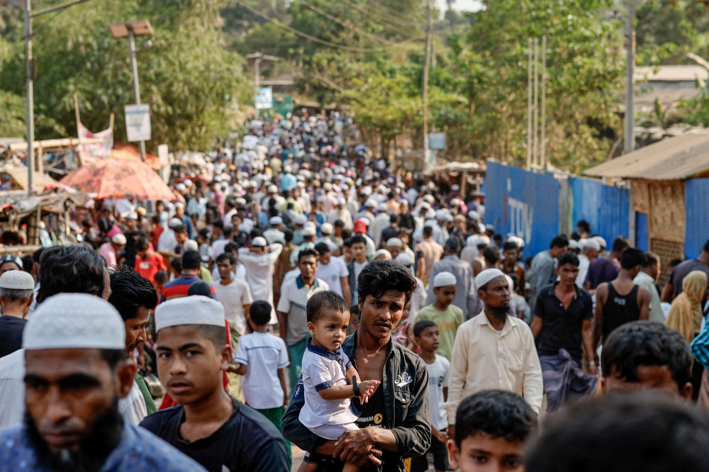 Rohingya refugees gather at roadside kitchen market, at the refugee camp in Cox's Bazar, Bangladesh March 15, 2025. — Reuters pic