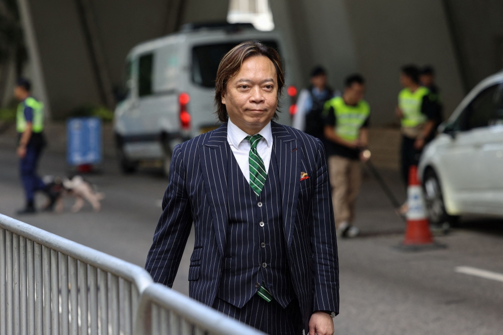 Barrister Lawrence Lau arrives at the West Kowloon Magistrates' Courts building, ahead of hearing appeals from 13 jailed pro-democracy activists in Hong Kong, China, July 14, 2025. — Reuters pic