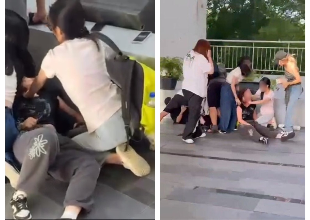 Several individuals attend to a woman who was injured in an alleged knife attack at a private university in Subang Jaya. — Screengrab via Whatsapp