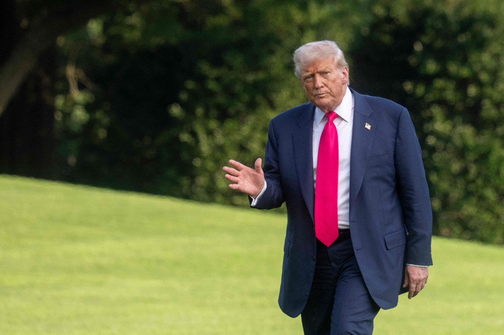 US President Donald Trump waves upon arriving at the White House in Washington, DC, July 15, 2025. Trump was returning from Pittsburgh, where he attended the inaugural Pennsylvania Energy and Innovation event. — AFP pic