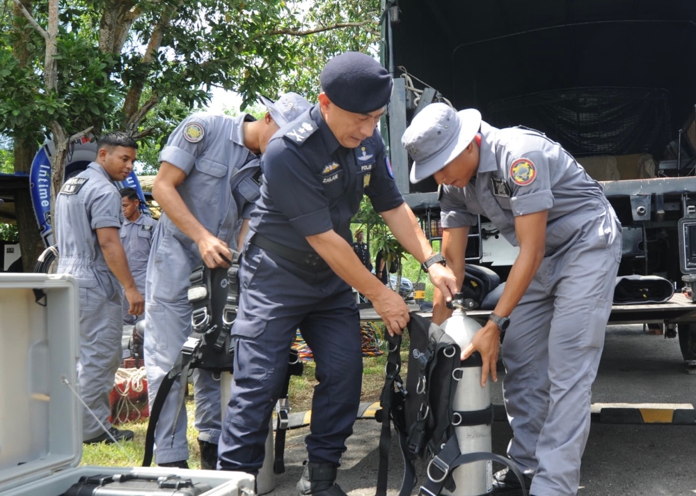 Johor police Internal Security and Public Order Department chief Muhd Zailani Abdullah helps prepare equipment for the recovery of the wrecked Airbus AS355N helicopter at the crash site in Sungai Pulai, Gelang Patah, Iskandar Puteri, July 16, 2025 — Picture by Ben Tan