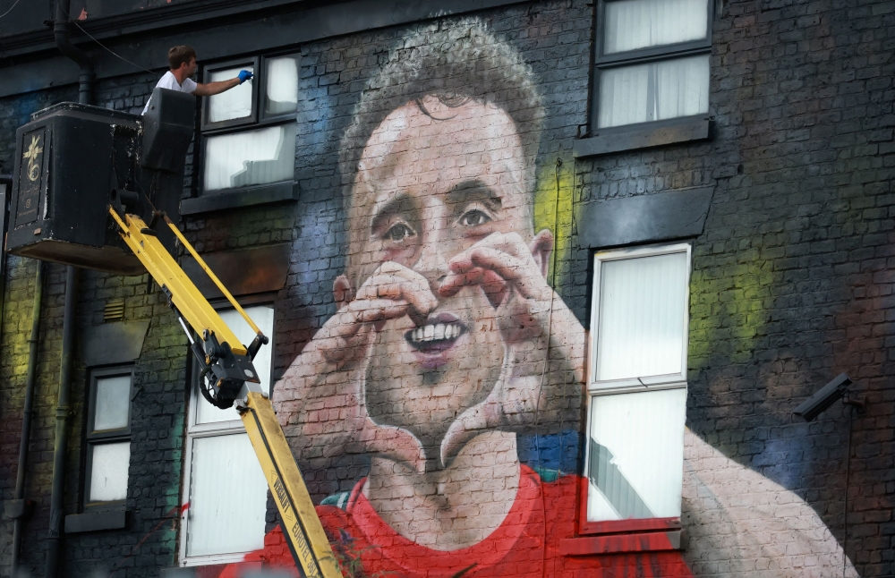 Artist John Culshaw works on a mural of late Liverpool player Diogo Jota on the side of a pub in Liverpool July 14, 2025. — Reuters pic