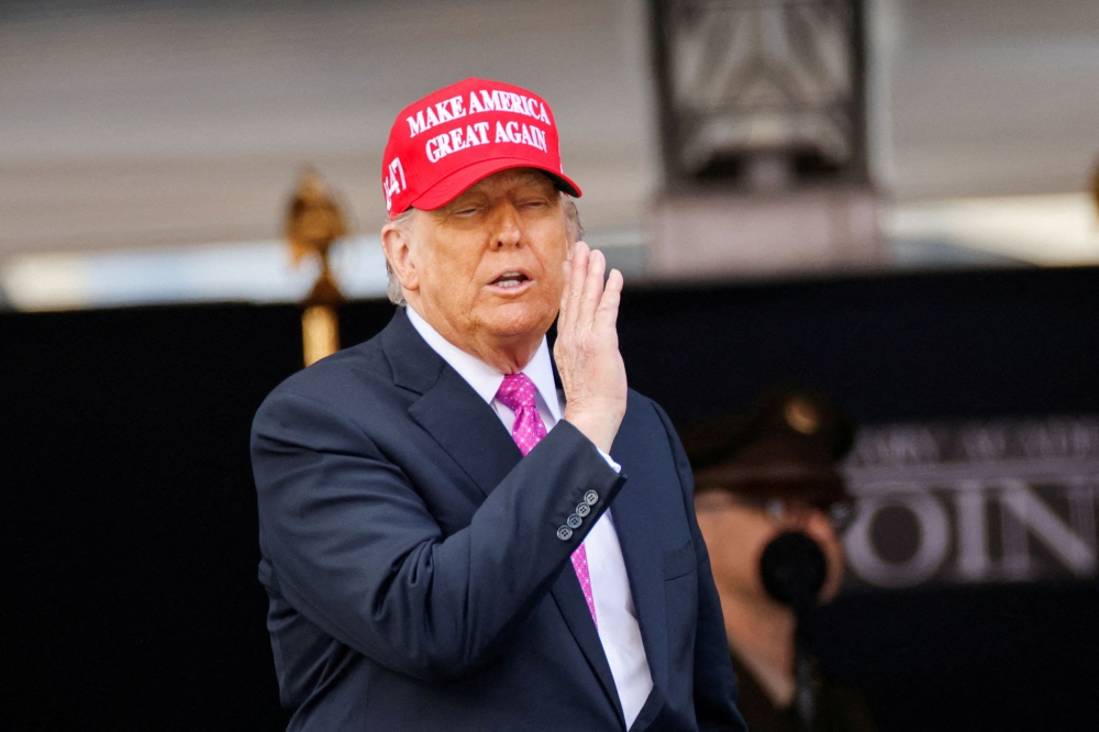 President Donald Trump wears a 'Make America Great Again' hat during the commencement ceremony at West Point Military Academy in West Point, New York, on May 24, 2025. — Reuters pic