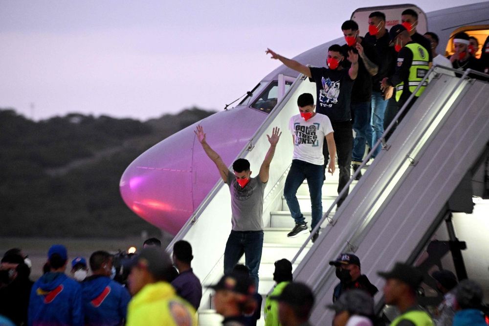 Venezuelan migrants who were jailed in El Salvador get off a plane at Simon Bolivar International Airport in Maiquetia, Venezuela July 18, 2025. — AFP pic