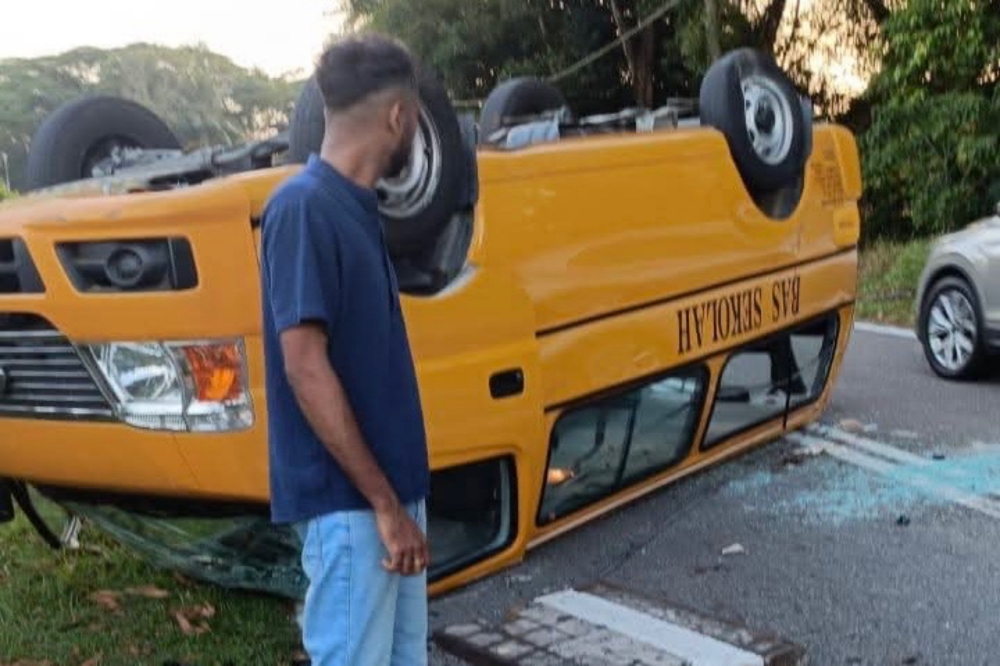 The overturned school bus that was involved in an accident after it flipped after hitting an open man hole along Jalan Abdul Samad in Johor Baru. July 18, 2025. — Picture from Facebook