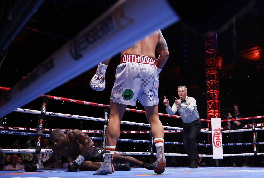 Ukraine's Oleksandr Usyk stands over Britain's Daniel Dubois during their undisputed world heavyweight boxing title bout at Wembley Stadium in London on July 19, 2025. — AFP pic