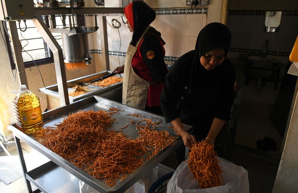 On most days, just one frying machine is used to produce 150kg of Muruku Bonda daily at the shop in Kubang Semang, Penang, but the second fryer picks up the load for festive days when demand soars. — Bernama pic