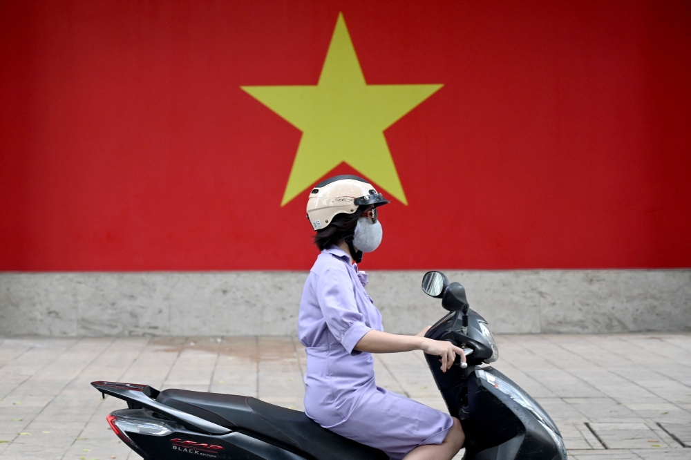 Hanoi authorities say they are considering alleviating the financial burden by offering subsidies of at least three million dong per switch to an e-bike, and also increasing public bus services. — AFP pic