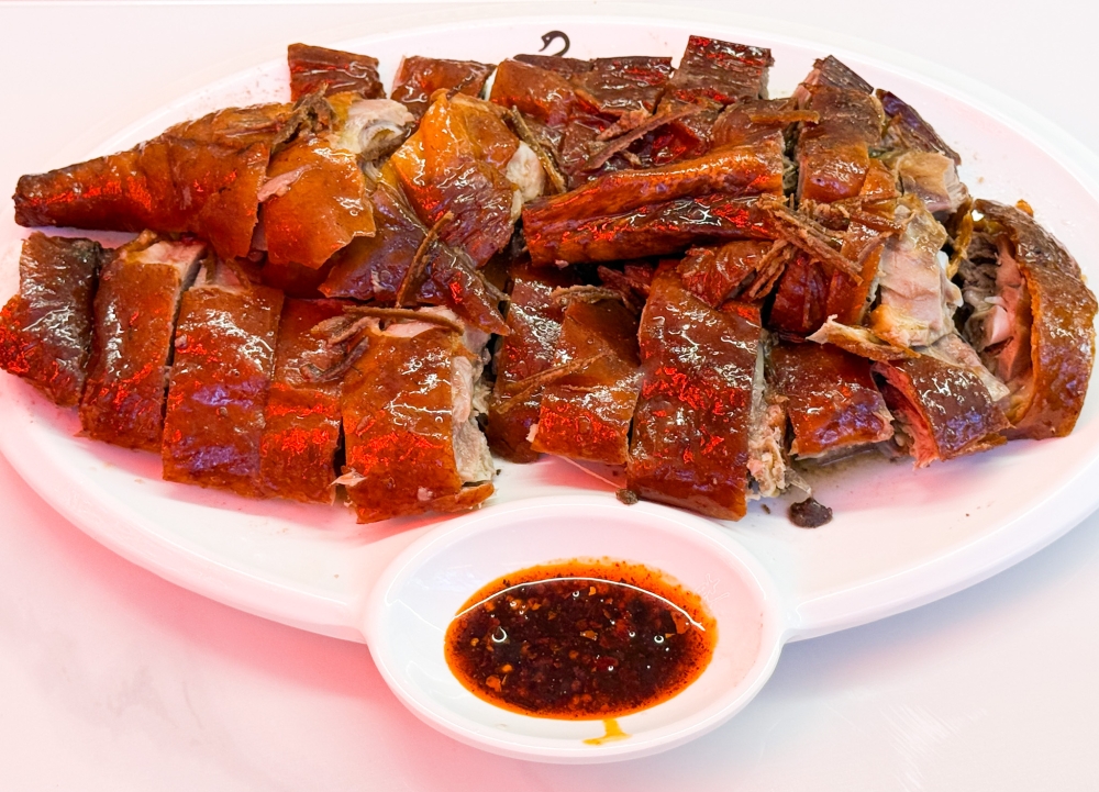 Half Roast Goose is best shared and enjoyed for its crispy light brown skin and juicy meat. — Picture by Lee Khang Yi