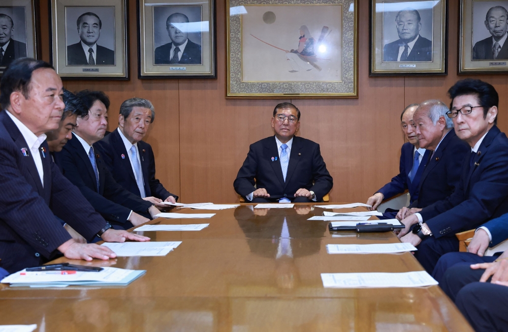 Japan’s Prime Minister Shigeru Ishiba (centre) attends an extraordinary executive meeting of the Liberal Democratic Party (LDP) at party headquarters in Tokyo on July 21, 2025, a day after his coalition lost its upper house majority. — AFP pic