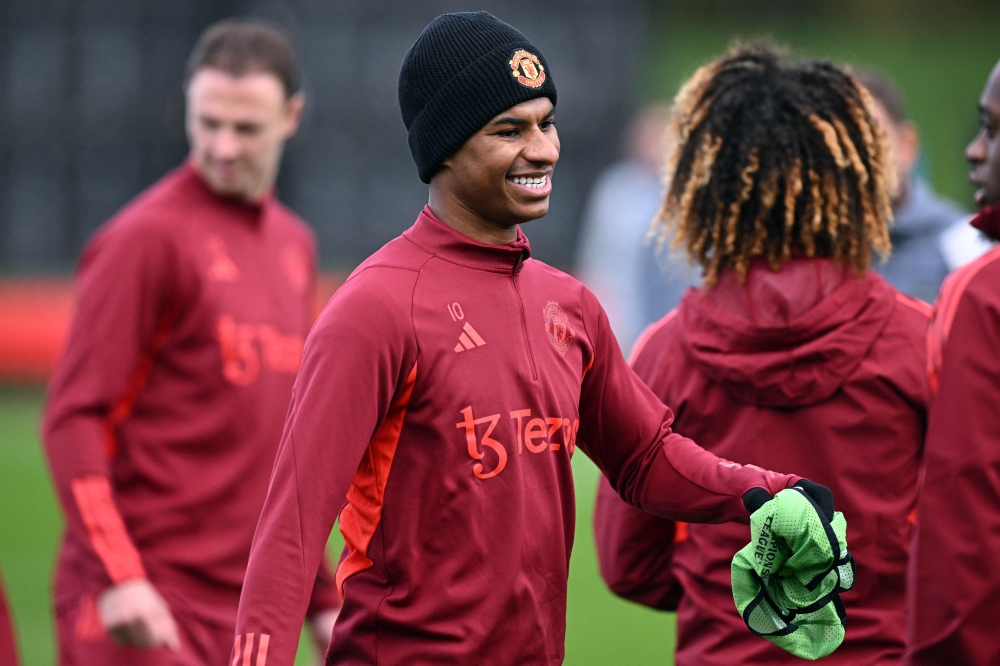 Manchester United's Marcus Rashford smiles as he attends a training session at the Carrington Training Complex in Manchester, on November 7, 2023. — AFP pic