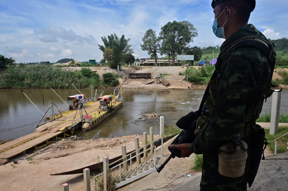 A Thai soldier guards a river crossing between Thailand and Myanmar in the border town of Mae Sot in Tak province on October 29, 2020. — AFP pic