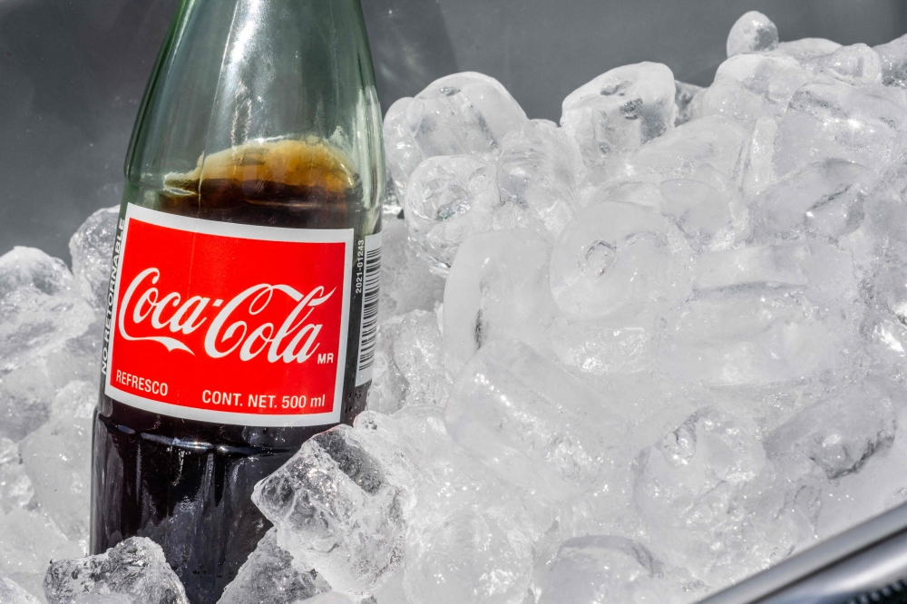 In this photo illustration, a Mexican Coke beverage is displayed in an ice-cooler at a park on July 17, 2025 in Austin, Texas. US President Donald Trump stated in a Truth Social post that Coca-Cola has agreed to use real cane sugar in its USbeverages, similar to Mexican Coke. — Getty Images pic via AFP