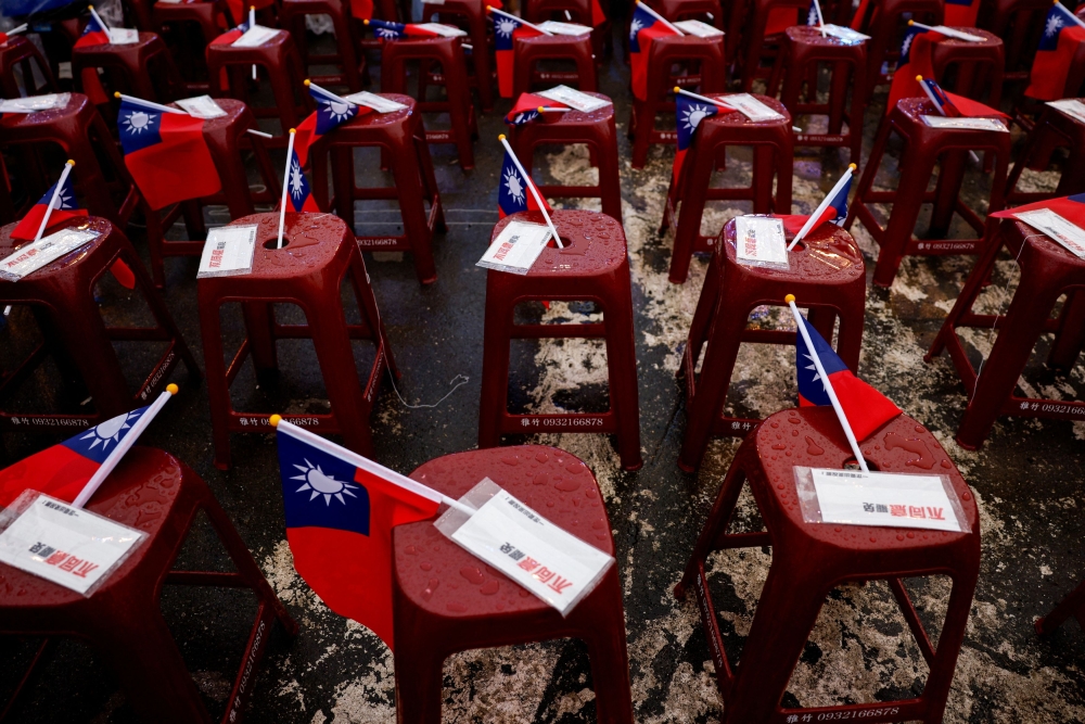 Signs against the recall movement and Taiwanese flags are kept on stools, as people gather in Taoyuan July 20, 2025. — Reuters pic