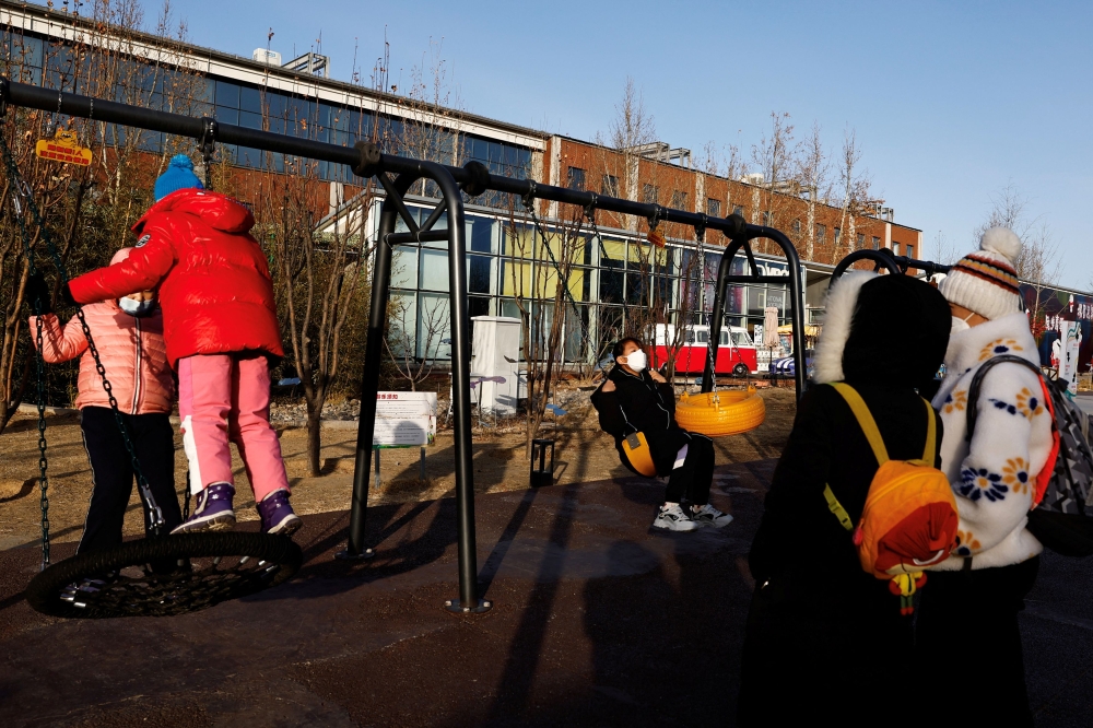Children play on swings at an outdoor playground in Beijing, China January 14, 2023. — Reuters pic