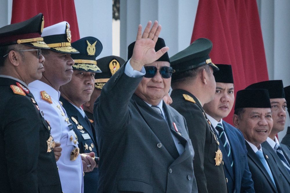 Indonesian President Prabowo Subianto waves during a commissioning ceremony for around 2,000 graduates from military and police academies at the Presidential Palace in Jakarta July 23, 2025. His administration has drawn criticism for increasingly involving the military in public services. — AFP pic