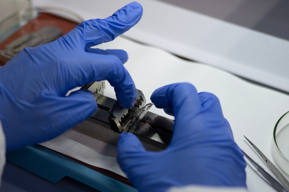 Belgian toxicologist Laura Pirard, specialized in marine mammals, works on biopsy samples of polar bear adipose tissue, in a laboratory onboard the science icebreaker vessel 'Kronprins Haakon' while sailing in eastern Spitzbergen, in the Svalbard archipelago, on April 9, 2025. — AFP pic 