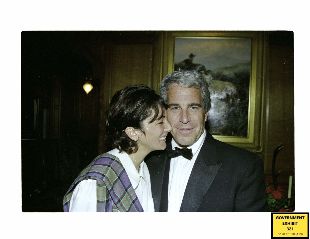 This undated handout trial evidence image from the US District Court for the Southern District of New York shows British socialite Ghislaine Maxwell and US financier Jeffrey Epstein. — AFP pic