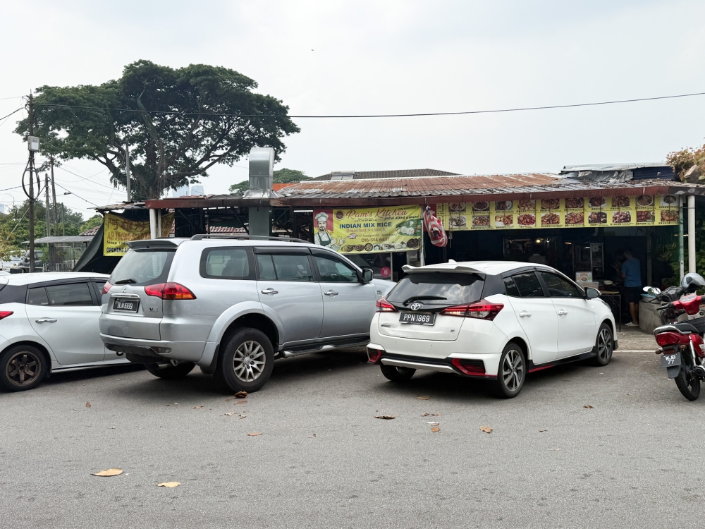 Outside various banners proclaim what stalls can be found inside the coffee shop to entice you inside. — Picture by Lee Khang Yi