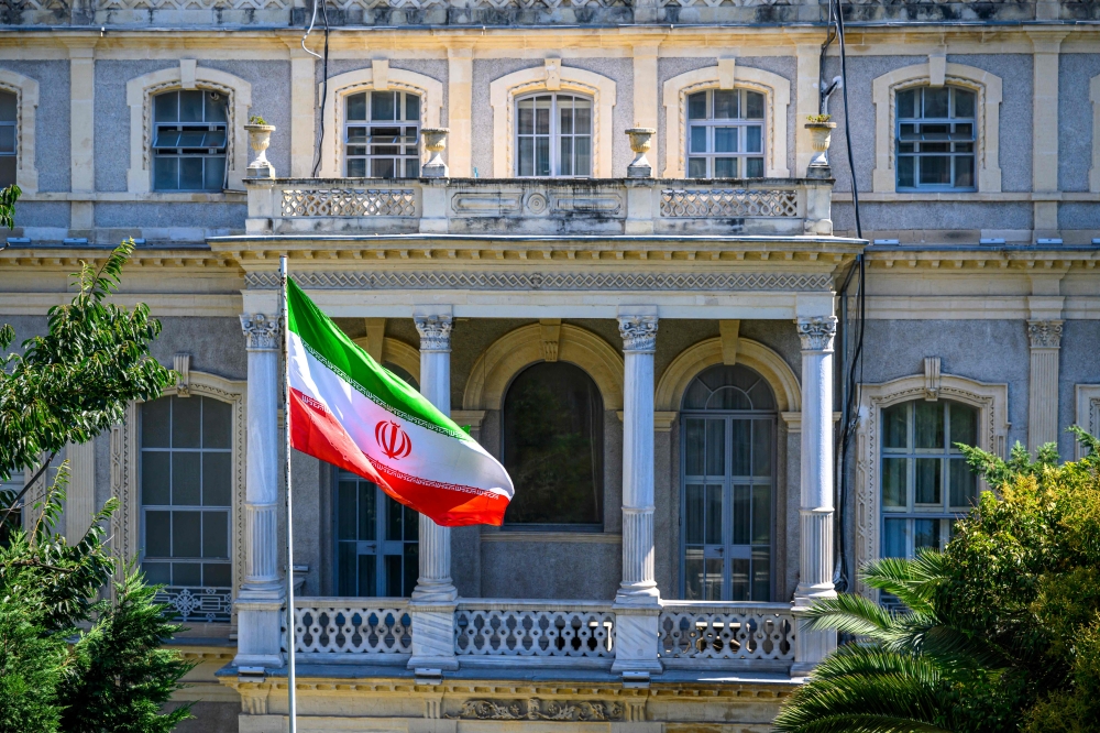An Iranian flag flutters in front of the Iranian Consulate, where Iranian diplomats meet counterparts from Germany, Britain and France for renewed nuclear talks, amid warnings that the three European powers could trigger ‘snapback’ sanctions outlined under the 2015 deal, in Istanbul, Turkiye, on July 25, 2025. The meeting will be the first since Israel's mid-June attack on Iran, which sparked a 12-day war and targeted key nuclear and military sites. — AFP pic 