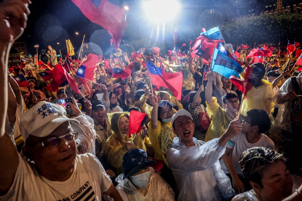 Supporters of Taiwan's main opposition party, Kuomintang (KMT), participate in a rally amid heavy rain against the recall election in front of the Presidential Office in Taipei yesterday. — AFP pic