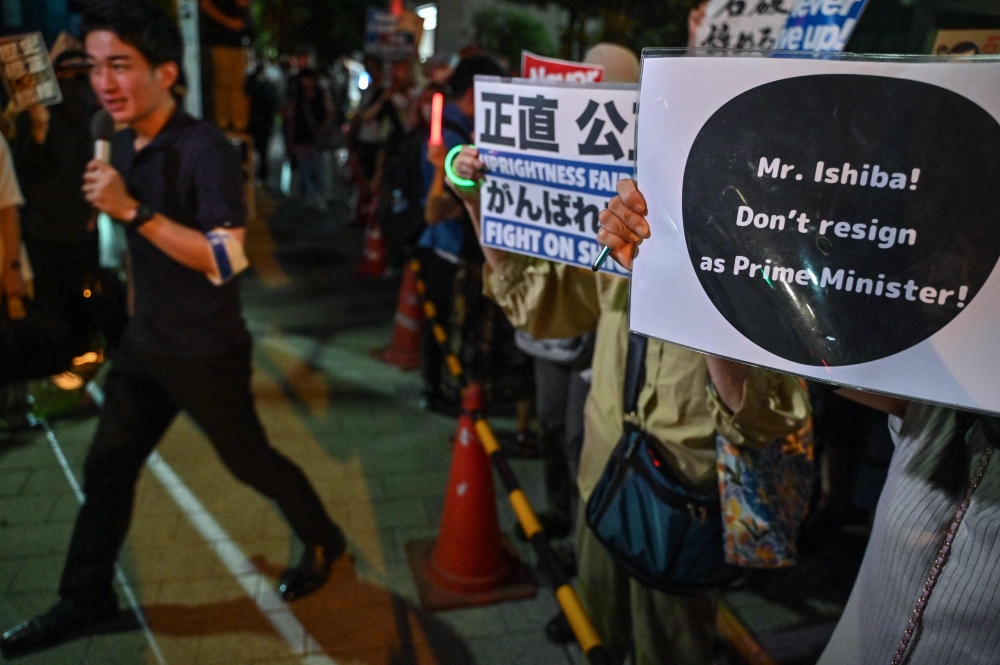 Supporters of Japan's Prime Minister Shigeru Ishiba take part in a rally across the street from the prime minister's office in central Tokyo July 25, 2025. — AFP pic 