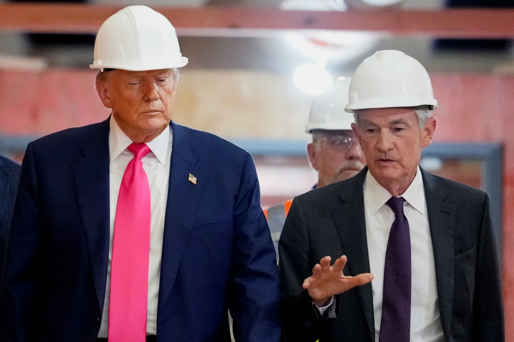 US President Donald Trump listens to Federal Reserve Chair Jerome Powell as they tour the Federal Reserve Board building, which is currently undergoing renovations, in Washington, D.C. July 24, 2025. — Reuters pic
