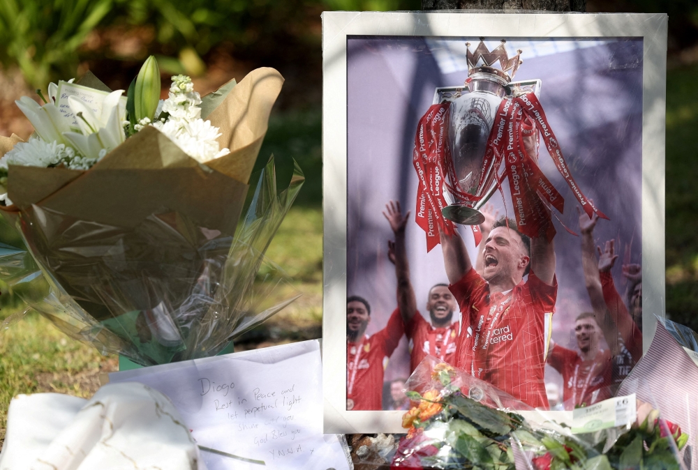 A picture of Liverpool’s Portuguese football player Diogo Jota stands next to flower tributes, after Jota died in a car crash near Zamora, Spain, outside Anfield Stadium in Liverpool July 3, 2025. — Reuters pic  