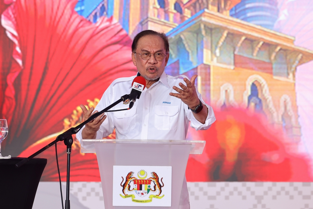 Prime Minister Datuk Seri Anwar Ibrahim delivering his speech at the Launch of the National Month and Fly the Jalur Gemilang 2025 campaign at Dataran Tanjung Emas in Muar. — Bernama pic