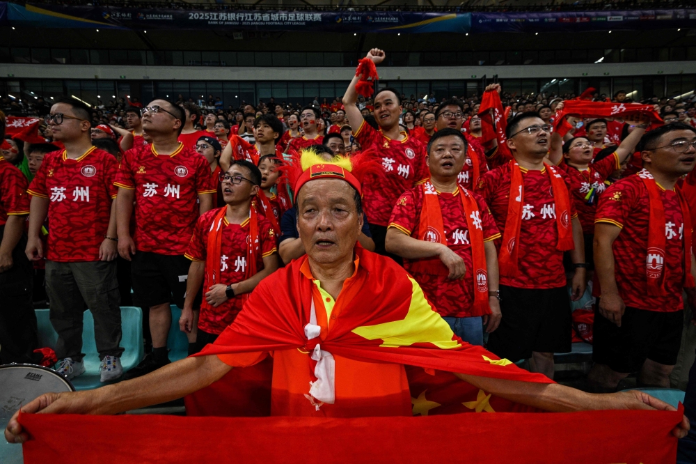 Suzhou fans watch the amateur league football match between Suzhou and Yangzhou at the Kunshan Olympic Sport Centre in Kunshan June 29, 2025. — AFP pic