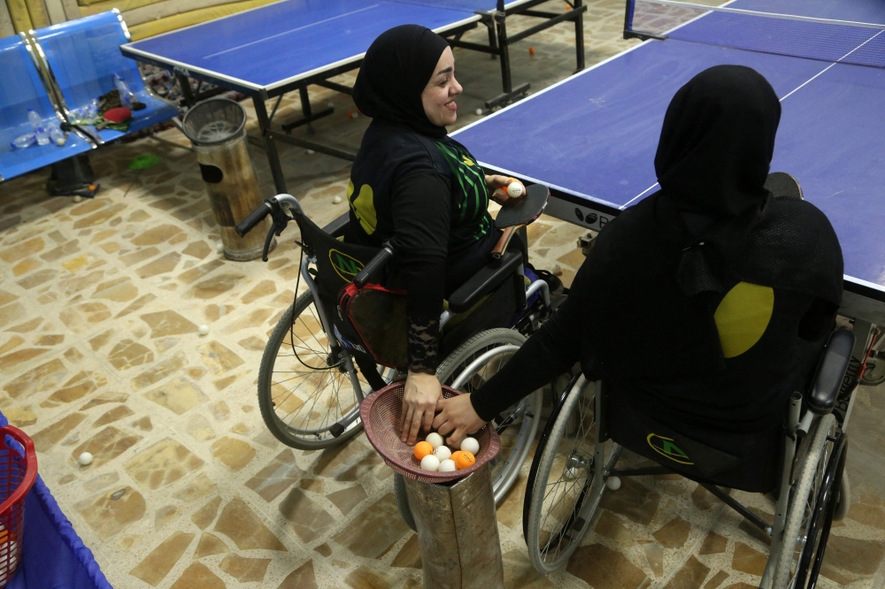 Disabled Iraqi table tennis players compete during a training session at a community centre in the southern city of Diwaniyah July 8, 2025. — AFP pic