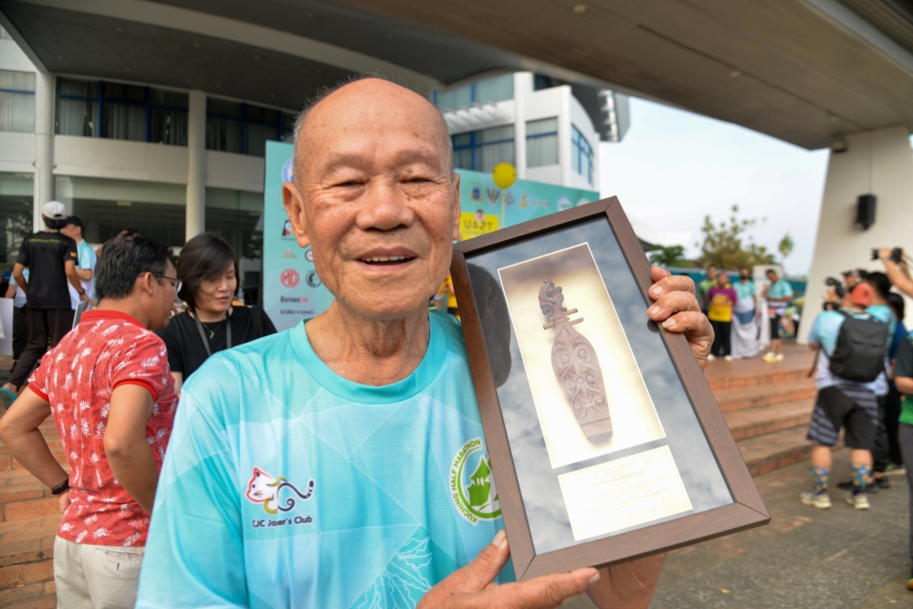 Wong poses for a photo after the prize presentation ceremony. — The Borneo Post pic